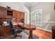 Home office with built-in cabinetry and hardwood floors at 39 Forked Pine Ct, Chapel Hill, NC 27517