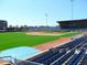 View of a baseball stadium with green field and blue seats at 512 Gordon St # 302, Durham, NC 27701