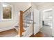 Elegant wooden staircase with wrought iron balusters leading to upper level at 3700 Lark Farm Rd, Franklinton, NC 27525