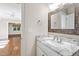 White vanity with granite countertop and a large mirror at 3700 Lark Farm Rd, Franklinton, NC 27525