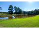 Serene pond with lush green grass at 3700 Lark Farm Rd, Franklinton, NC 27525