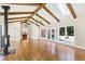 Great room with exposed beams, hardwood floors, and fireplace at 3700 Lark Farm Rd, Franklinton, NC 27525