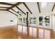 Great room with exposed beams, hardwood floors, and pond views at 3700 Lark Farm Rd, Franklinton, NC 27525
