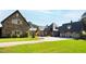 Stone and shingle exterior of a luxurious home with a large driveway and manicured lawn at 3700 Lark Farm Rd, Franklinton, NC 27525