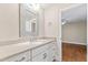 White vanity with granite countertop and decorative mirror at 3700 Lark Farm Rd, Franklinton, NC 27525