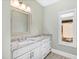 Bathroom with white vanity, granite countertop, and window at 3700 Lark Farm Rd, Franklinton, NC 27525