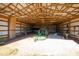 Large barn interior with tractor and equipment at 3700 Lark Farm Rd, Franklinton, NC 27525