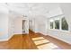 Bright bedroom with hardwood floors, large window, and access to bathroom at 3700 Lark Farm Rd, Franklinton, NC 27525