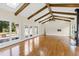 Great room with exposed beams, hardwood floors, and access to patio at 3700 Lark Farm Rd, Franklinton, NC 27525