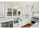 Modern kitchen with farmhouse sink, white cabinets and granite countertops at 3700 Lark Farm Rd, Franklinton, NC 27525