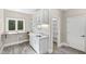 Bright laundry room with built-in cabinetry, sink, and window at 3700 Lark Farm Rd, Franklinton, NC 27525