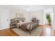 Bedroom with hardwood floors, metal bed frame, and window at 3700 Lark Farm Rd, Franklinton, NC 27525