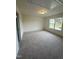 Large bedroom with carpeted floor and a window with natural light at 23 Quail Pt Cir, Clayton, NC 27520