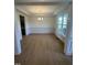 Formal dining room with hardwood floors, wainscoting, and chandelier at 23 Quail Pt Cir, Clayton, NC 27520