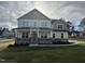 Two story house with gray siding, stone accents, and a large front yard at 23 Quail Pt Cir, Clayton, NC 27520