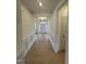 Hallway with hardwood floors and wainscoting, leading to other rooms at 23 Quail Pt Cir, Clayton, NC 27520