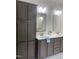 Double vanity bathroom with dark wood cabinets and a large mirror at 6733 Oscar Barham Rd, Wake Forest, NC 27587
