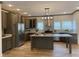 Spacious kitchen featuring an island, stainless steel appliances, and light wood flooring at 6733 Oscar Barham Rd, Wake Forest, NC 27587
