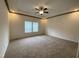 Spacious bedroom with carpeted floor, ceiling fan, and two windows at 6733 Oscar Barham Rd, Wake Forest, NC 27587