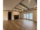 Spacious living room with hardwood floors, a stone fireplace, and high ceilings at 6733 Oscar Barham Rd, Wake Forest, NC 27587