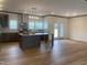 Open concept kitchen and living area with an island and hardwood floors at 6733 Oscar Barham Rd, Wake Forest, NC 27587