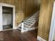 Wood staircase with detailed banister and wood flooring at 414 E Morehead St, Burlington, NC 27215