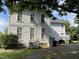 Rear view of a two-story home showing additional building and AC unit at 414 E Morehead St, Burlington, NC 27215