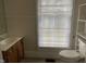 Simple bathroom with toilet, sink, and window at 414 E Morehead St, Burlington, NC 27215