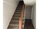 Carpeted staircase with wooden railing leading to the upper level at 414 E Morehead St, Burlington, NC 27215