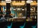 Upscale bar interior with green chairs and a long bar at 202 Byrum St # 2, Cary, NC 27511
