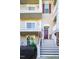 Three-story house with brick and siding, featuring a front porch and stairs at 10420 Sablewood Dr # 115, Raleigh, NC 27617