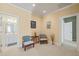 Relaxing sitting area with two chairs and a small table, located near a bathroom and hallway at 12217 Beestone Ln, Raleigh, NC 27614