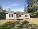 Rear view of a house with a deck and large backyard at 1872 Billy T Trl, Mebane, NC 27302