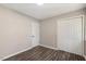 Well-lit bedroom with double doors and wood-look floors at 712 Blount St, Smithfield, NC 27577