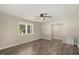 Living room with wood floors, ceiling fan, and window at 712 Blount St, Smithfield, NC 27577