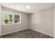 Simple bedroom with wood-look floors and a window at 712 Blount St, Smithfield, NC 27577