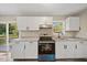 Updated kitchen featuring white cabinets and granite countertops at 712 Blount St, Smithfield, NC 27577