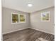 Bright bedroom featuring light gray walls and wood-look flooring at 712 Blount St, Smithfield, NC 27577