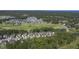 Aerial view of a large community with houses, a golf course, and a lake at 562 Legacy Falls S Dr, Chapel Hill, NC 27517