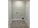 Laundry room with wire shelving and gray vinyl flooring at 2034 Fishamble St, Fuquay Varina, NC 27526