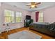 Bright bedroom with hardwood floors, large windows, and ceiling fan at 636 Palmer Dr, Sanford, NC 27330