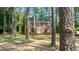 Brick house with walkway, surrounded by tall trees at 636 Palmer Dr, Sanford, NC 27330