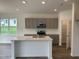Modern kitchen featuring gray cabinets, quartz countertops, and an island at 87 Furley St., Homesite 112, Sanford, NC 27330