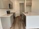 Gray kitchen cabinets, stainless steel appliances, and an island at 87 Furley St., Homesite 112, Sanford, NC 27330
