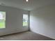 Simple bedroom with two windows and carpet flooring at 87 Furley St., Homesite 112, Sanford, NC 27330