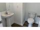 Simple bathroom with pedestal sink, toilet, and mirror at 87 Furley St., Homesite 112, Sanford, NC 27330