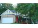 Two-story house with brick and siding, a red door, and a two-car garage at 65 Applegate Dr, Franklinton, NC 27525