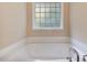 Bathroom with soaking tub and window at 65 Applegate Dr, Franklinton, NC 27525