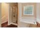 Bathroom with shower, tub, and window at 65 Applegate Dr, Franklinton, NC 27525