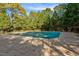 Community pool with a green cover and surrounding trees at 65 Applegate Dr, Franklinton, NC 27525